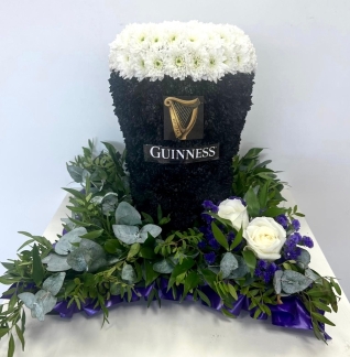 3D Guinness funeral tribute, created with sprayed chrysanthemum and mixed foliage cushion base. 