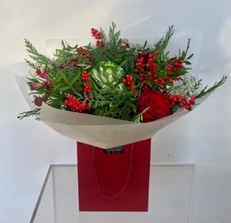Ilex berries, Brassica, Roses, Astrantia and Alstroemeria. The perfect mix of red, white and green including a mix of complimentary foliage. 