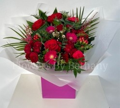 Stunning bouquet filled with rich red and cerise florals perfect for your loved one. 