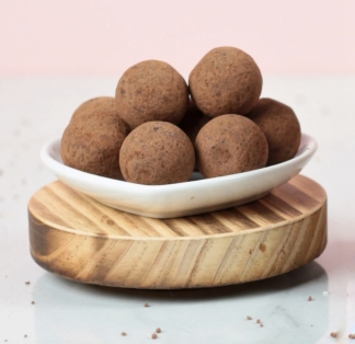  A tray of six cocoa dusted chocolate truffles with a delicious salted caramel filling. 