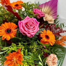 Hand tied gift bouquet in water. Design includes pink roses, orange germini, yellow solidago, orange celosia, peach carnation, oakleaf and spear palms. 