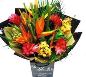 Tropical mix of flowers including ginger, orchids and heliconia. 