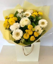 Mixed hand tied of roses, germini and chrysanthemum in yellows and whites. 