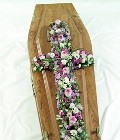 Loose pink and white funeral cross including roses, carnation and lizianthus. 