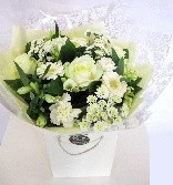 Bouquet made of pure white flowers, including roses, germini, carnations and chrysanthemums. 