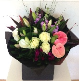 Luxury bouquet including roses, calla lily, anthuriums, celosia and mixed foliage. 