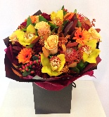 Beautiful bouquet in autumnal tones including roses, orchids and germini. 
