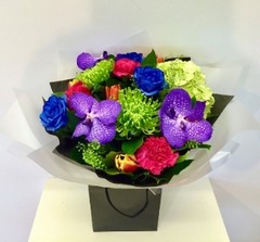 Extraordinary hand tied including blue roses, purple vander orchids and a mix of traditional vibrant flowers. 