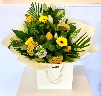 Hand tied in fresh lemon and green tones,including lily, roses, snapdragons, celosia and chrysanthemums. 