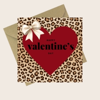 Valentine’s Day card with leopard print background, large red heart, satin-style ivory bow and the text Happy Valentine’s Day, paired with a kraft envelope.