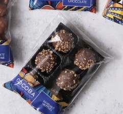 A tray of six indulgent hazelnut chocolate truffles decorated with real chopped hazelnuts. 