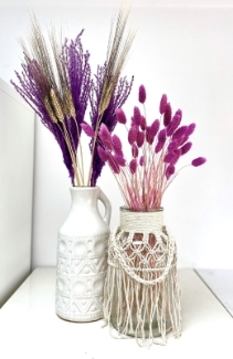 Mixed vase display with bright pink and purple dried flowers. 