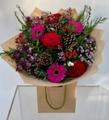 This joyful bouquet boasts a mix of pink and red tones. Including Roses, Germini, Astrantia, Wax Flower, Hypericum, Willow & Pine Cones. 