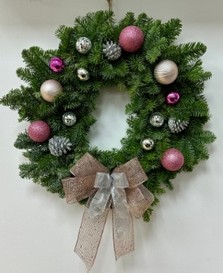 Fresh spruce wreath with pink baubles, disco ball's, pine cones and a big pink glitter bow. 