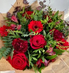 Roses, germini, carnation and alstroemeria with complimentary foliage to finish the design. 
