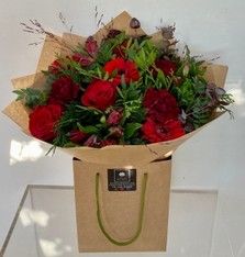 Roses, germini, carnation and alstroemeria with complimentary foliage to finish the design. 