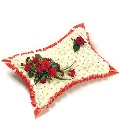 Traditional massed pillow funeral tribute made with chrysanthemum and a mix of seasonal flowers. 