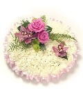 Pink and white massed funeral posy. 