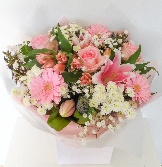 Soft pink and white bouquet including lily, roses and germini. 