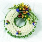 Massed wreath with bright coloured focal flowers. 